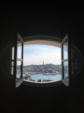 Çatı katındaki oval bir pencereden şehir manzarası. İnsanlığa yeni bir pencere fotoğrafı..