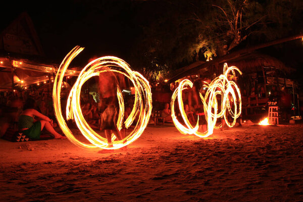 Three strong men juggling fire dancing on the sairee beach koh tao Surat Thani province Thailand 