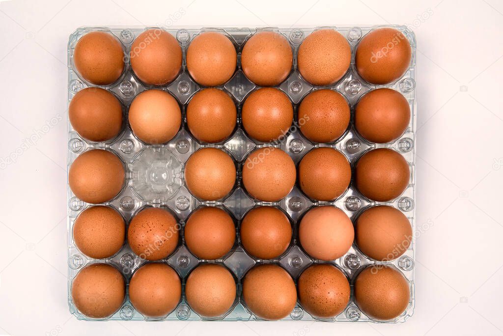 Organic extra large eggs pack of thirty but one is missing. View from the top. 