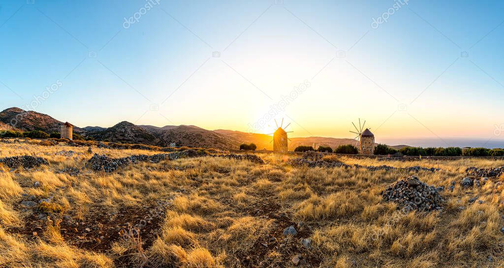 Sunset mountain landscape with old windmills, Creta island.