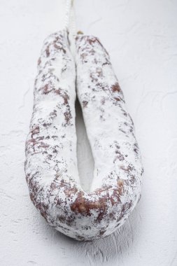 Beyaz desenli arka planda salam sosis fueti.