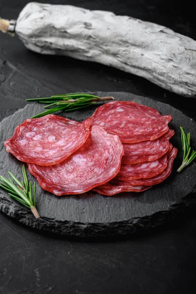 Dry Cured Whole Slices Cuts Salchichon Sausage Black Textured Surface — Stock Photo, Image