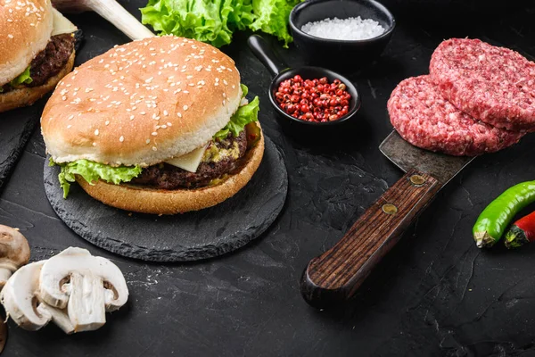 Burger with meat on butcher cleaver on black background.