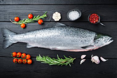 Siyah ahşap yüzeyde taze çiğ somon balığı filetosu..