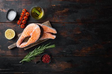 Kırmızı balık alabalığını otlarla dilimle, eski ahşap masada, düz manzaralı metin için..