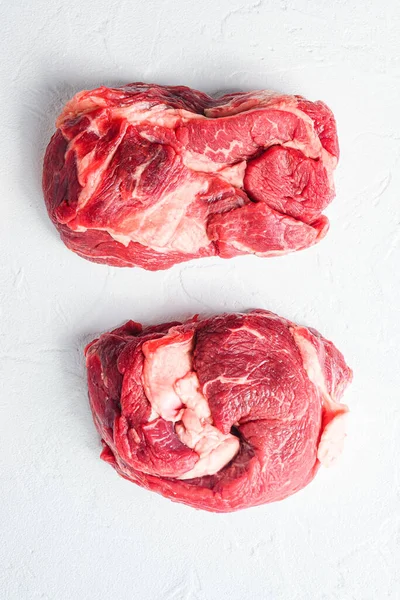 Raw Chuck eye roll steak. Organic beef. White textured background. Top view