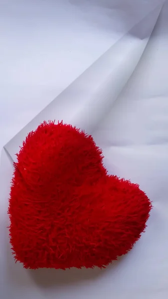 a picture of Red heart on folded white paper