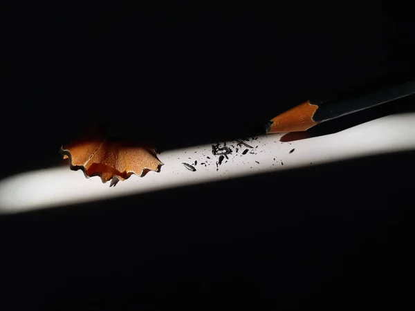 a picture of broken  Pencil  on black background