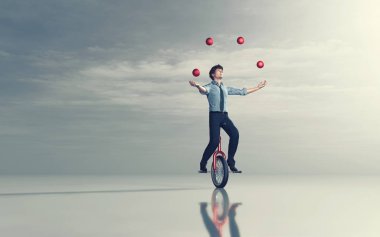 Juggling on unicycle clipart