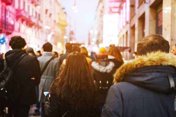 people crowd walking on busy street