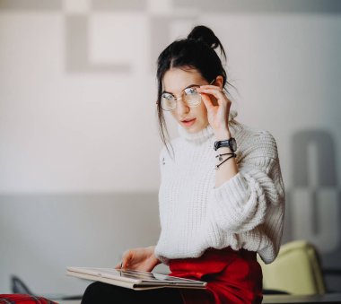 Tablet kullanarak gözlük ile esmer kadın