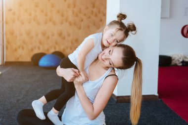 Anne kızını kollarına aldı.