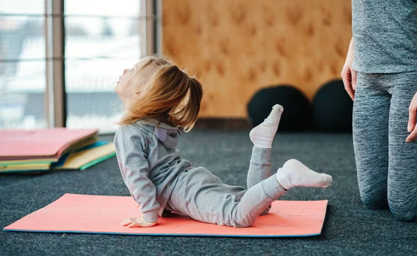 Una niña repite ejercicios para su madre — Foto de Stock