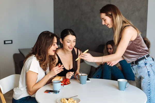 Tre kvinna vänner frukost i köket — Stockfoto