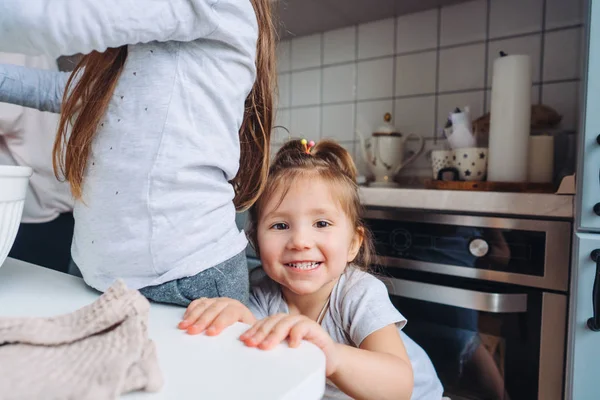 Two little girls cook in the kitchen — Stock Photo, Image