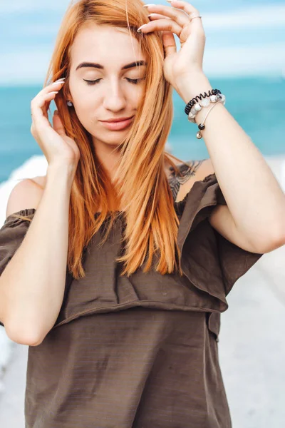 Ung kvinna med rött hår poserar på kameran — Stockfoto