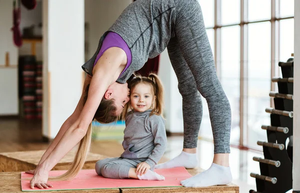 Mamá e hija juntas realizan diferentes ejercicios — Foto de Stock