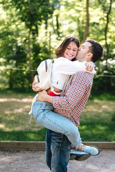 Happy young family walking in the park — Stock Photo, Image