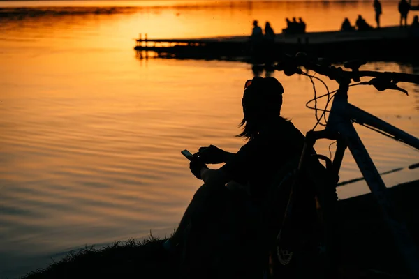 Una ragazza riposa sulla riva del fiume . — Foto Stock