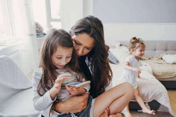 Máma a dcera se díváte na smartphone — Stock fotografie