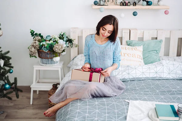 Gadis yang duduk di tempat tidur dengan kotak ini — Stok Foto