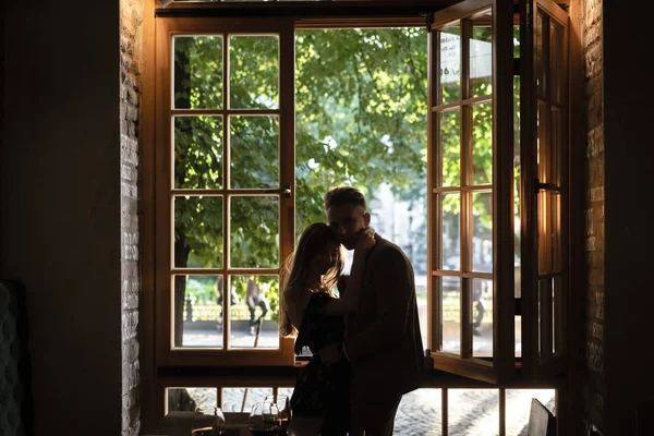 Young couple by the window — Stock Photo, Image