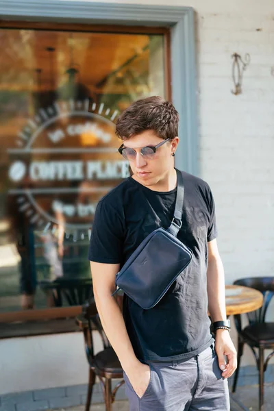 Young guy in round sunglasses posing on camera. — Stock Photo, Image