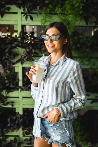 stock image Beautiful young woman with plastic cup of fresh cocktail