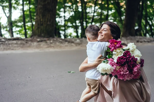 Glückliche Mutter mit ihrem kleinen Sohn im Sommerpark. — Stockfoto