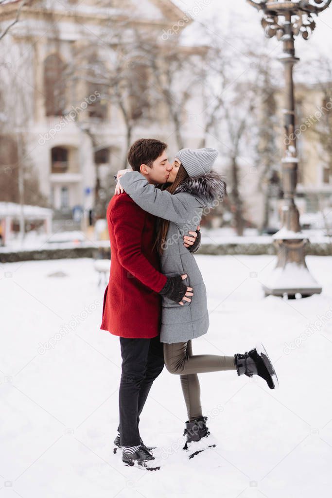 A young guy and a girl are hugging each other