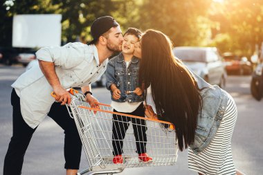 Genç ailesi oğullarının bir sepeti koymak ve Park öp.