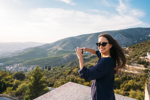 Girl posing on camera in the background coastal city