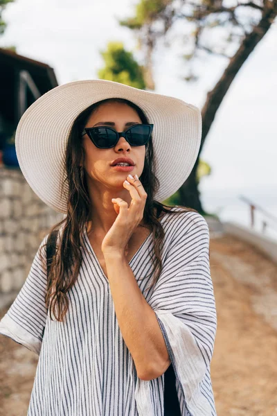 Attractive woman goes to the sea. The girl is resting, having fun.