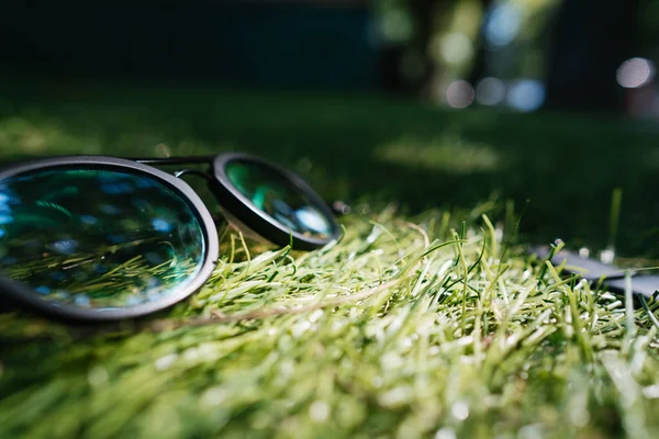 Сонцезахисні окуляри лежать на траві, близький кут — стокове фото