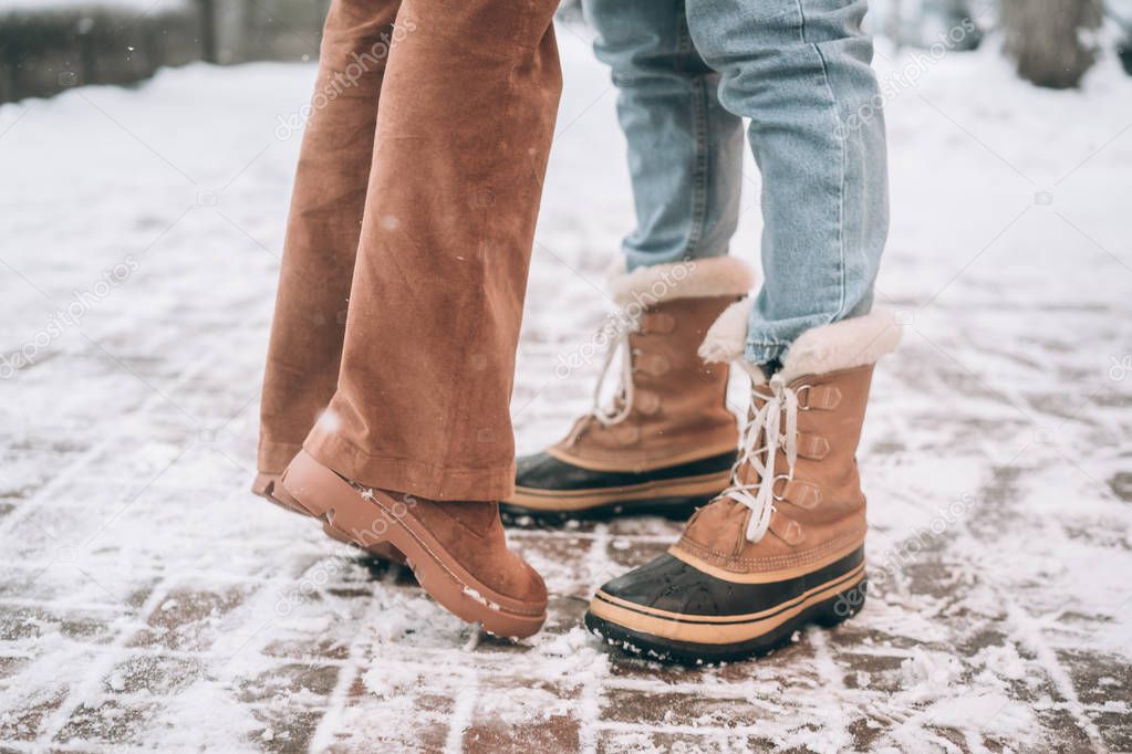 boyfriend and girlfriend posing for the camera, legs only