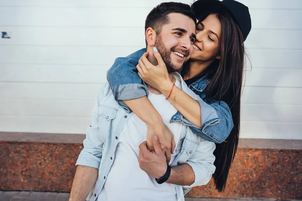 Young beautiful girl hugging her handsome boyfriend — Stock Photo, Image