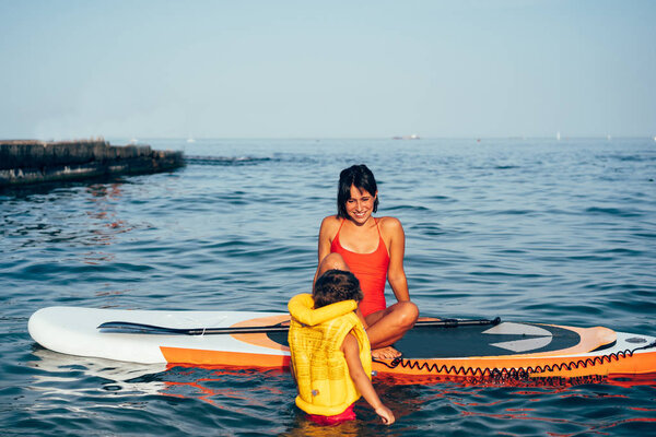 Mother with daughter on a paddle board Stock Picture