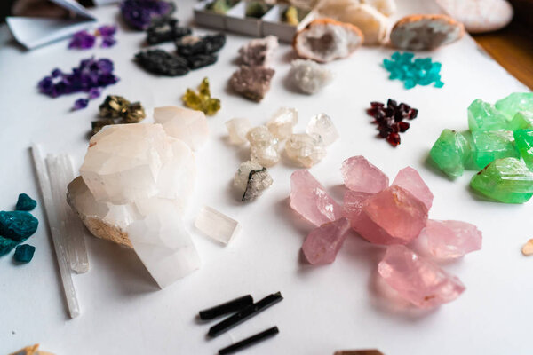 Collection of beautiful precious stones on white table.
