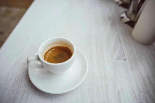 Cup of cappuccino on the white wooden table. — Stock Photo, Image