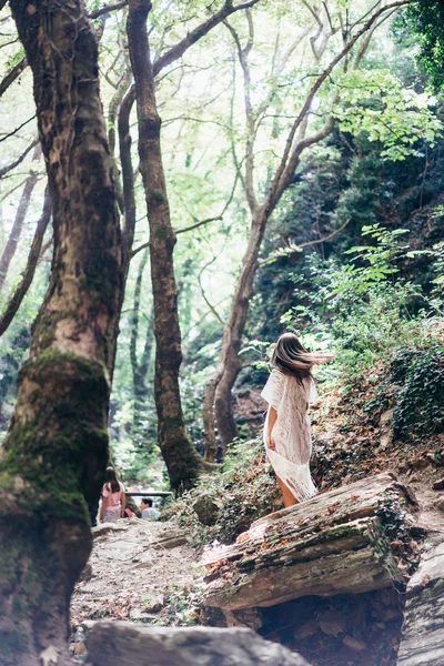Beautiful, young girl walks at the foot of the mountain along — Stock Photo, Image