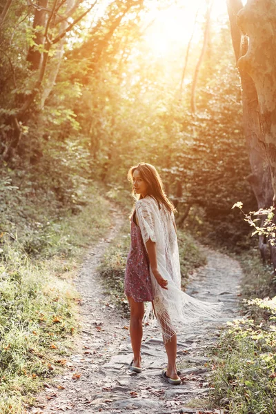 Beautiful, young girl walks at the foot of the mountain along — Stock Photo, Image