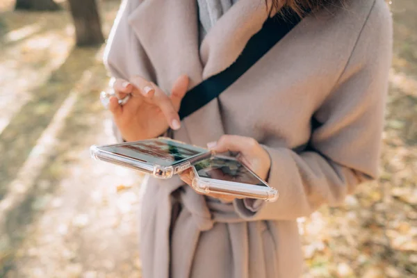 아름 다운 젊은 여자는 그녀의 손 두 스마트폰 보유 하 — 스톡 사진