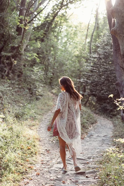 Beautiful, young girl walks at the foot of the mountain along — Stock Photo, Image