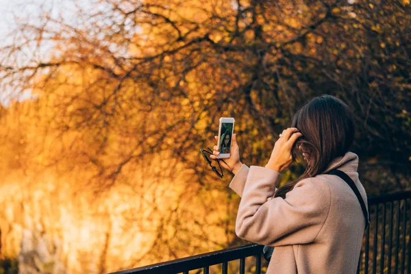 Frau macht Selfie im Herbstpark — Stockfoto