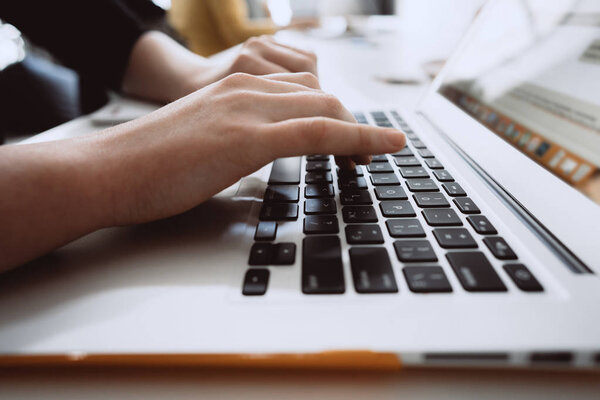 Close-up of hands of businessman typing on a laptop.