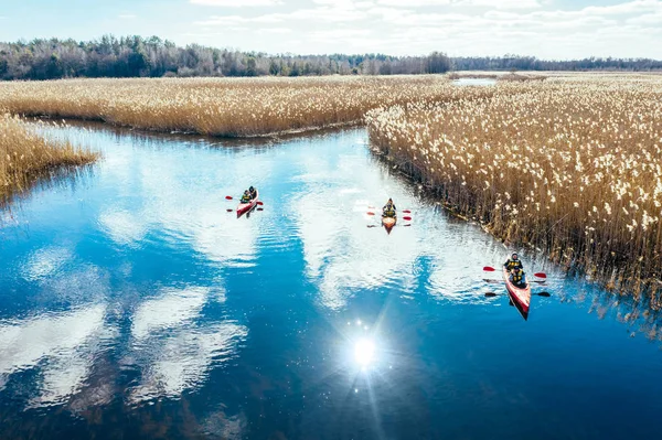 Grupo de personas en kayaks entre cañas en el río de otoño . — Foto de Stock