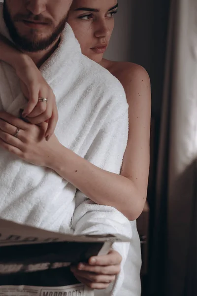 Guy in a white coat and a girl in a towel — Stock Photo, Image