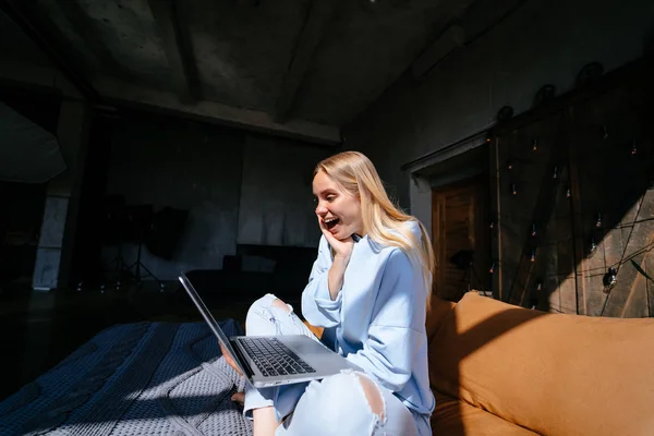 Χαμογελαστή ελκυστική γυναίκα που βρίσκεται στο κρεβάτι χρησιμοποιώντας φορητό υπολογιστή — Φωτογραφία Αρχείου