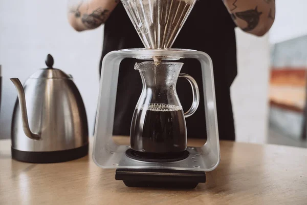 Close up of a barista making hand brewed coffee.