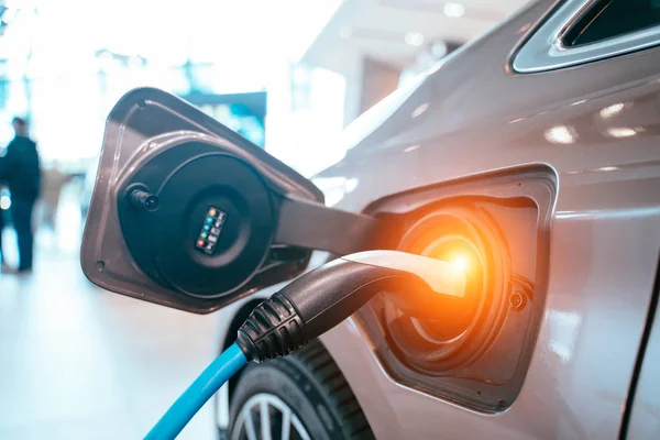 Power supply plugged into an electric car being charged. — Stock Photo, Image
